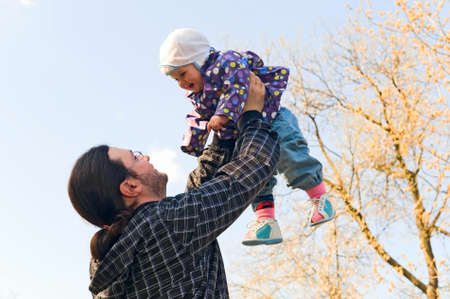 father and child at a park on a sunny dayの写真素材