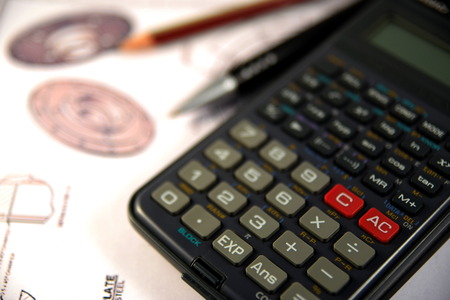 Scientific calculator Pen and Pencil over the Engineering Drawing Mapの写真素材