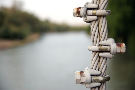 Close up Bridge Steel Cable with River Backgroundの写真素材
