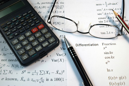 Eye Glasses, pen and pencil over the Formula with calculatorの写真素材