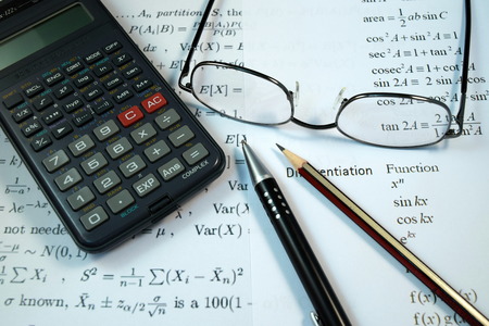 Eye Glasses, pen and pencil over the Formula with calculatorの写真素材