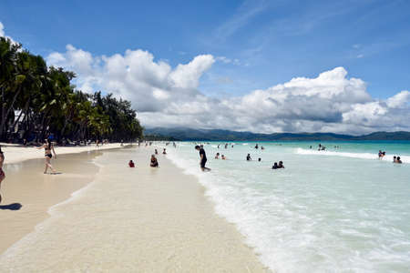 Boracay Island, Philippines, July 10, 2022, happy family, Mother and kids playing in white sand...