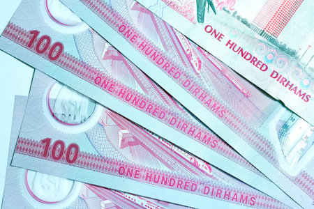 A high-quality, top-down view of United Arab Emirates currency (AED), featuring a mix of colorful...