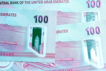 A high-quality, top-down view of United Arab Emirates currency (AED), featuring a mix of colorful...
