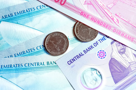 A high-quality, top-down view of United Arab Emirates currency (AED), featuring a mix of colorful...