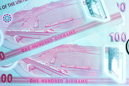 A high-quality, top-down view of United Arab Emirates currency (AED), featuring a mix of colorful...