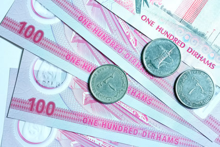 A high-quality, top-down view of United Arab Emirates currency (AED), featuring a mix of colorful...