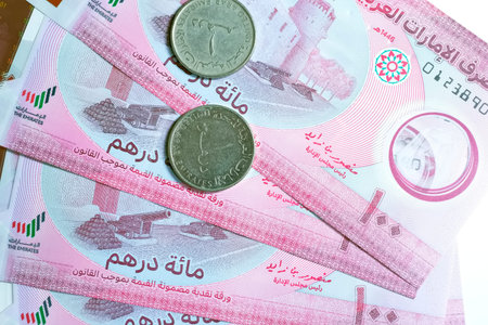 A high-quality, top-down view of United Arab Emirates currency (AED), featuring a mix of colorful...