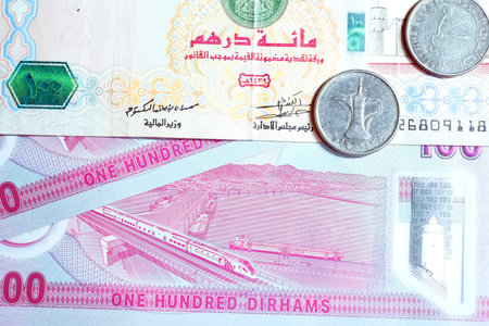 A high-quality, top-down view of United Arab Emirates currency (AED), featuring a mix of colorful...
