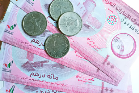 A high-quality, top-down view of United Arab Emirates currency (AED), featuring a mix of colorful...