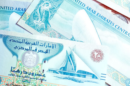 A high-quality, top-down view of United Arab Emirates currency (AED), featuring a mix of colorful...