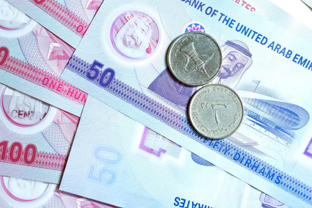 A high-quality, top-down view of United Arab Emirates currency (AED), featuring a mix of colorful...