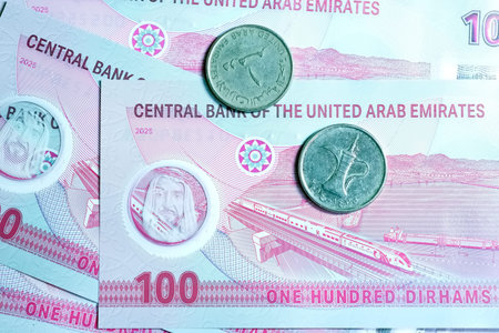 A high-quality, top-down view of United Arab Emirates currency (AED), featuring a mix of colorful...
