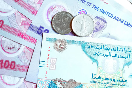 A high-quality, top-down view of United Arab Emirates currency (AED), featuring a mix of colorful...