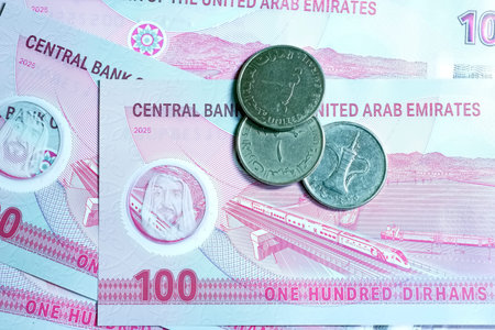 A high-quality, top-down view of United Arab Emirates currency (AED), featuring a mix of colorful...