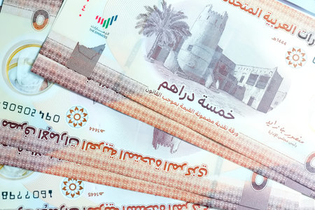 A high-quality, top-down view of United Arab Emirates currency (AED), featuring a mix of colorful...