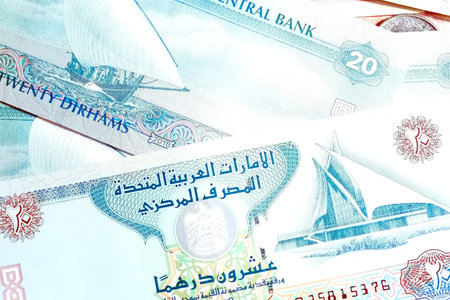 A high-quality, top-down view of United Arab Emirates currency (AED), featuring a mix of colorful...