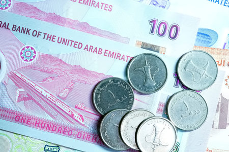 A high-quality, top-down view of United Arab Emirates currency (AED), featuring a mix of colorful...