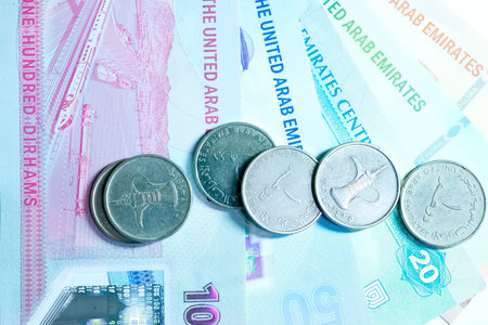 A high-quality, top-down view of United Arab Emirates currency (AED), featuring a mix of colorful...