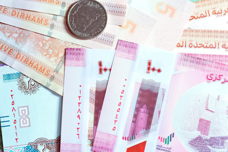 A high-quality, top-down view of United Arab Emirates currency (AED), featuring a mix of colorful...