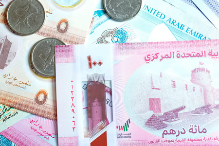 A high-quality, top-down view of United Arab Emirates currency (AED), featuring a mix of colorful...