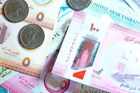 A high-quality, top-down view of United Arab Emirates currency (AED), featuring a mix of colorful...