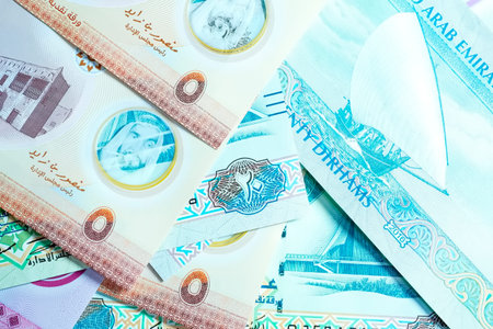 A high-quality, top-down view of United Arab Emirates currency (AED), featuring a mix of colorful...