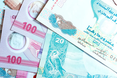 A high-quality, top-down view of United Arab Emirates currency (AED), featuring a mix of colorful...