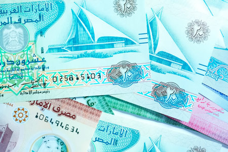 A high-quality, top-down view of United Arab Emirates currency (AED), featuring a mix of colorful...