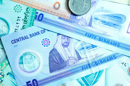 A high-quality, top-down view of United Arab Emirates currency (AED), featuring a mix of colorful...