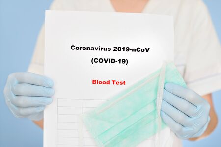 Nurse with COVID-19 test result.の写真素材