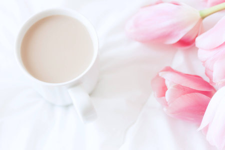 Womans work place in bed. Top view. Breakfastの写真素材