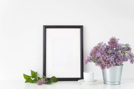 Black frame with lilac bouquet on white backgroundの写真素材
