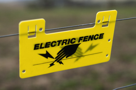 Electric fence sign, A clear sign to anyone not to touch or wee near the wiresの写真素材
