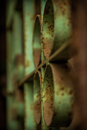Rounded pattern old dusty and rusty trellis window from abandon old houseの写真素材