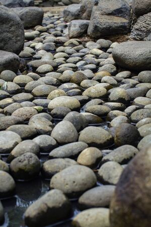 Beautiful naturally rounded stones in the dry pondの写真素材