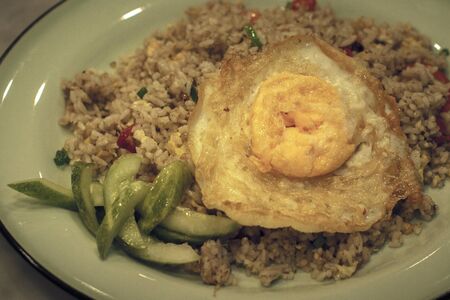 Special kaempferia galanga fried rice served with eggs and picklesの写真素材