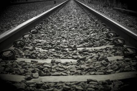 Close-up train rail track in a black and white picture