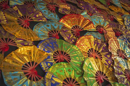 Traditional hand fan on display as a photography backgroundの写真素材