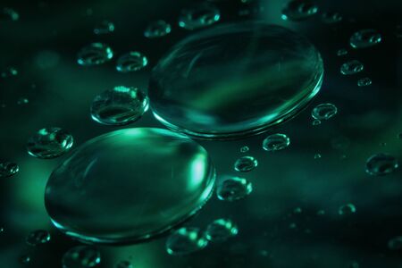 Floating cooking oils on the water create a nice composition, colour and imaginationの写真素材