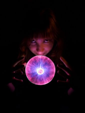 Purple plasma flames drawing from center to margin of sphere; Ball illuminate girl face.の写真素材