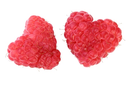 two ripe red heart-shaped raspberries over white backgroungの写真素材