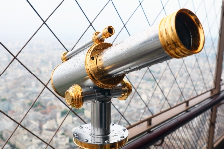 Telescope mounted on top of the Eiffel Tower observation deck. It is wet after rain. View to Paris.の写真素材