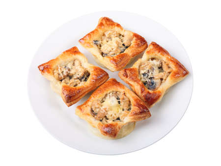 four edible puff pastry baskets with Julien on a white round dish isolated over white background.の写真素材