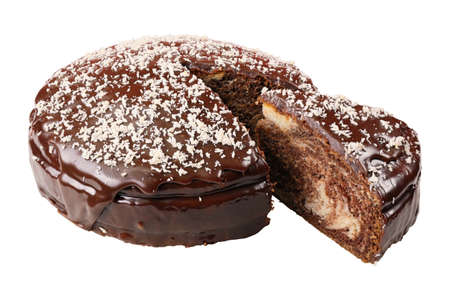 glazed cake sprinkled with coconut flakes with piece cut out isolated on white background.の写真素材
