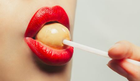 Young beautiful girl with lollipop in her mouthの写真素材