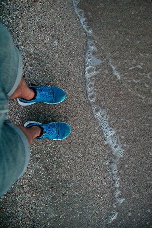 someone entering the sea water without swimsuitの写真素材