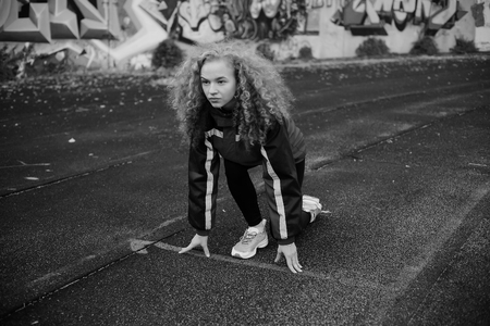 girl standing at low start to the stadiumの写真素材