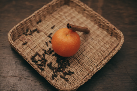 tangerines, orange slices, stars cardamom and cinnamon sticks on a wooden tableの写真素材