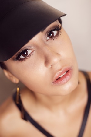 Close-up portrait of a beautiful sexy young woman in a leather visor and sword belt, beauty...